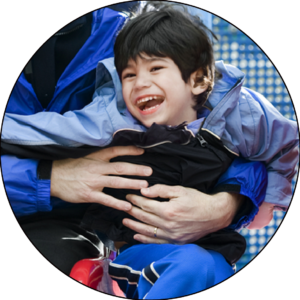 young child with a disability laughing